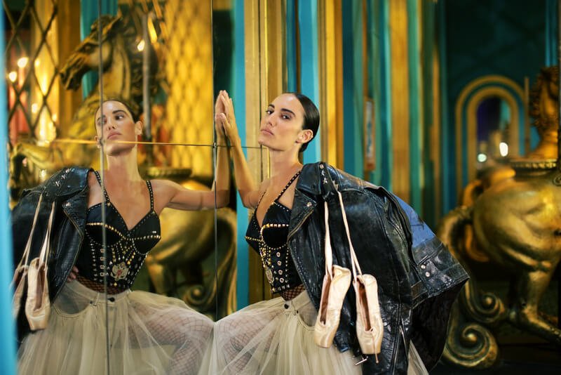 woman in a leather bustier and tulle skirt with pointe shoes