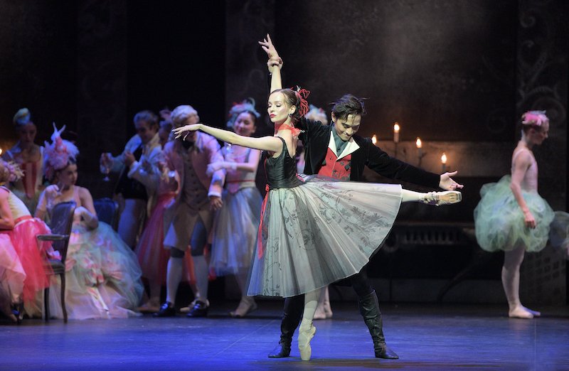 A male dancer shows off a ballerina in arabesque