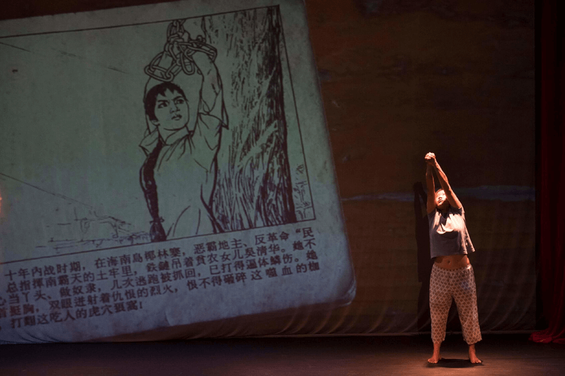 Dancer poses next to cartoon projection